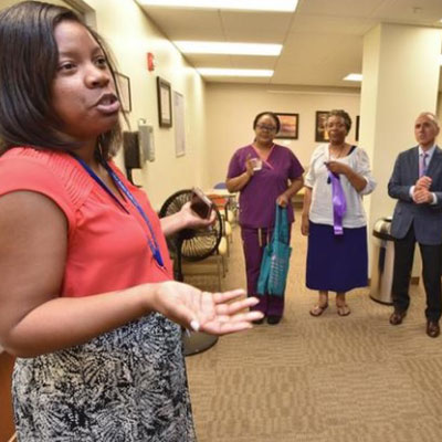 Chase Brexton's JaNee Deline leads a tour during the Glen Burnie Center Open House in April 2017.