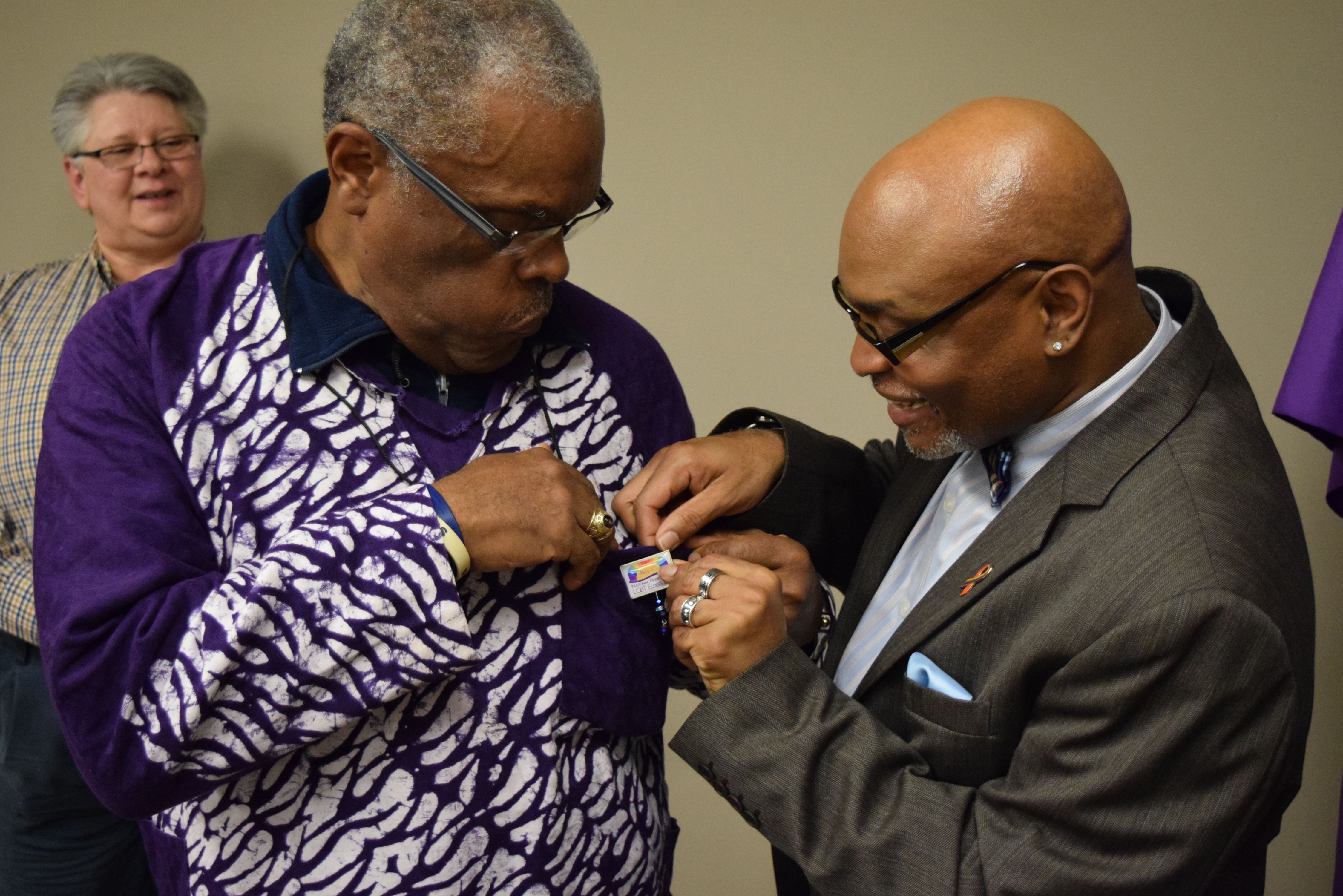 Pinning ceremony, photo of Carlton Smith putting a pin on Louise Hughes